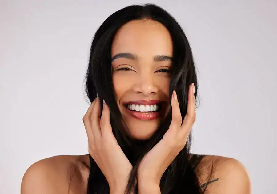 Image of woman with silky, black hair smiling at camera