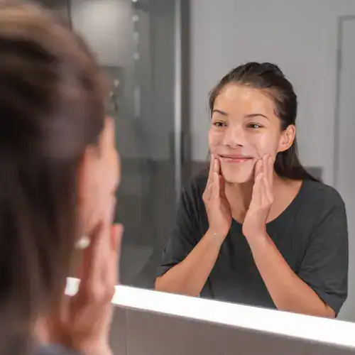 Woman cleansing her face