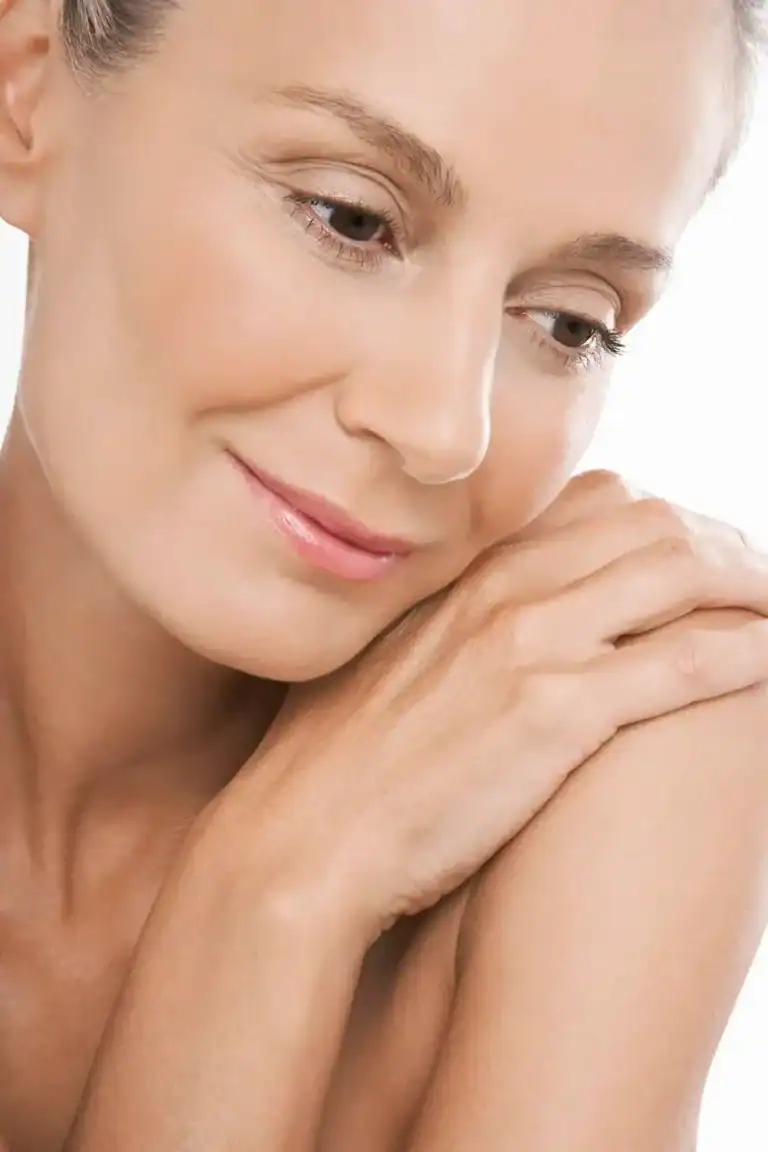 Image of woman feeling her smooth skin